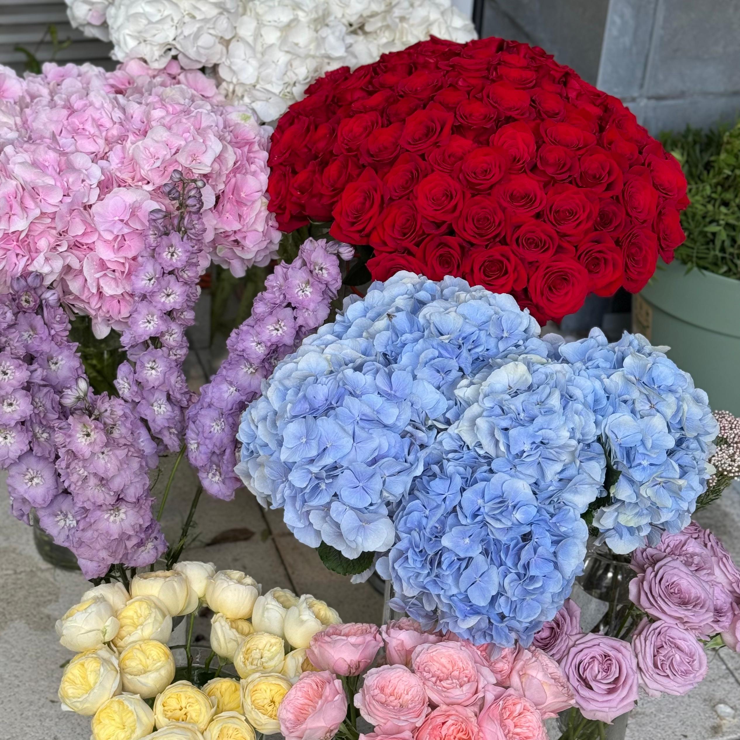 Picture of multiple roses and hortensias in vases